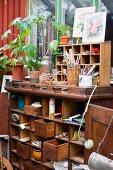 Old wooden cabinet containing gardening utensils