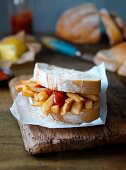 A chip butty with ketchup