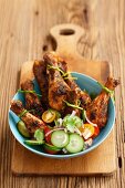 Spicy roast chicken legs with a vegetables salad
