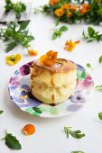 A scone with sugar syrup and tufted pansies