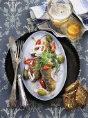 Fried herring with chilli and capers served with Aquavit and beer (Scandinavia)
