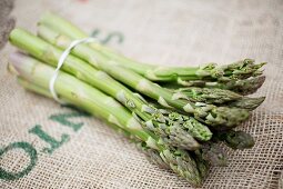 Green asparagus on a piece of jute
