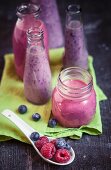 Bottles of raspberry and blueberry smoothie