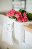 Bouquet of pink roses in white sink