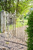 Sunny garden with wrought iron gate