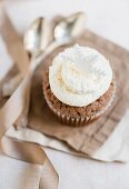 A chocolate cupcake decorated with buttercream and a snowflake (Christmas)