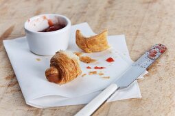 A croissant, jam and a knife