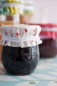 Jars of jam with covers upcycled from oilcloth remnants and ribbons