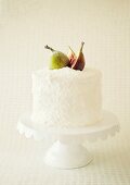 A coconut cake with fresh figs