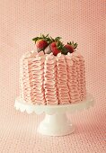A strawberry cake with chocolate dipped strawberries