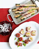 Christmas appetisers: grissini with asparagus and ham, crostini with smoked salmon, ricotta and courgette, stuffed cherry tomatoes