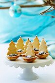 Tartlets decorated with chocolate and Christmas tree biscuits