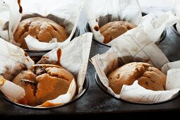 Vanilla and cranberry muffins in a muffin tin