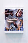 Various sausages and bacon in a box