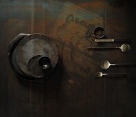 Rustic crockery and cutlery on a dark surface