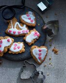 Ginger biscuits with icing sugar and sugar hearts