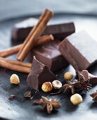 Chocolate, nuts and spice on a black plate