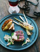 Steak with mushroom sauce, fennel and potato wedges for New Year's Eve