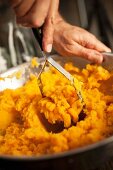 Mashed sweet potatoes being made
