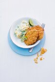 Turkey escalope with a crisp coating served with mashed potatoes