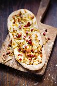 Onion cake with diced bacon on a chopping board