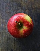 An apple on a wooden surface