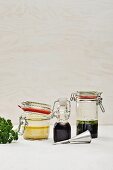 Three different marinades in jars and a bottle