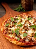 Rustic pizza with sausage, cheese and basil