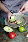 Guacamole being made: flesh being removed from an avocado