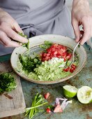 Guacamole being made: ingredients being mixed together