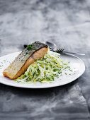 Fried salmon fillet on a bed of white cabbage