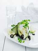 Avocado with melon, watercress and olives