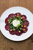 Beetroot carpaccio with goat's cheese, croutons and fresh herbs