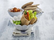 Pita breads stuffed with mince sauce, peppers and lettuce