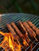 Minced meat skewers on a barbecue