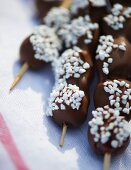 Chocolate-glazed, sugar-coated grapes on sticks for a spring picnic
