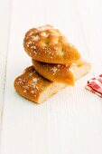 Three pieces of focaccia stacked on a wooden surface