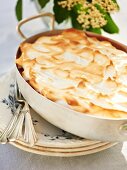 Rhubarb cake with elderflower syrup in a baking tin