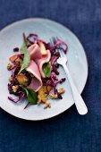 Smoked duck breast on a bed of red cabbage and apple salad with cranberries