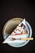 A slice of ricotta almond cake with plums