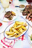 Grilled potatoes and grilled beef steaks