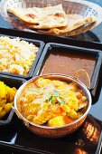 Navratan korma with curried potatoes, rice, lentils and naan bread