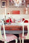 Nostalgic dining area with lit candles and bowl of winter apples on dining table