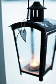 Lit tealight in black lantern