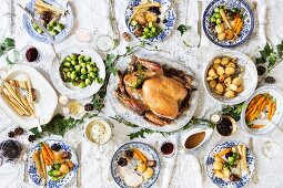 Christmas dinner with turkey, parsnips, Brussels sprouts, potatoes, carrots, gravy and cranberry sauce