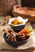 Spiced Moroccan lamb shanks with baby carrots and potato wedges