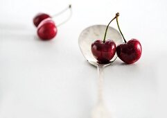 Pairs of cherries with a spoon