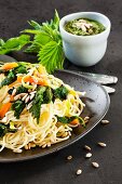 Spaghetti with stinging nettles, carrots and sunflower seeds