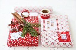 Wrapped Christmas presents (washi tape, block prints, cinnamon sticks, cord, pastry cutter)