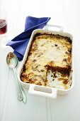 Moussaka in a baking dish with a slice cut out